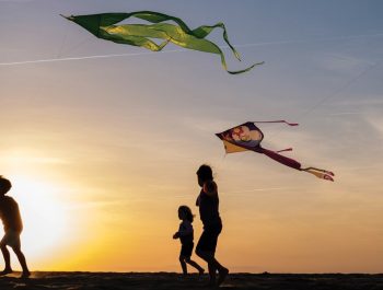 kids with kites at sunset on Jockey's Ridge
