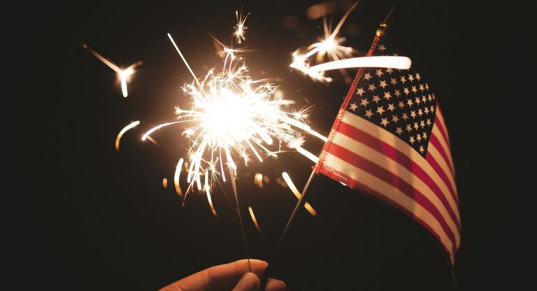 Fourth of July sparkler and American flag