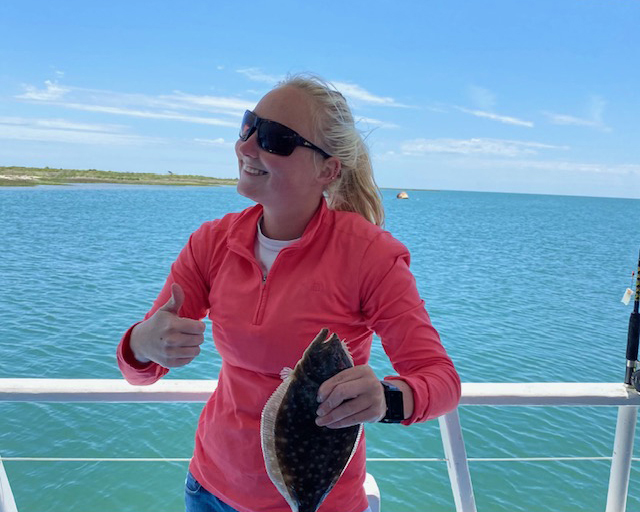 MATE TAYLOR2 mate Taylor on the Miss Oregon Inlet Headboat holding a flounder